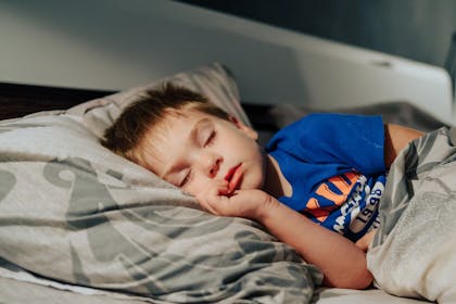 Little boy asleep in bed