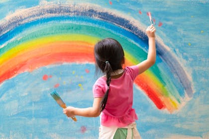 Child painting a rainbow