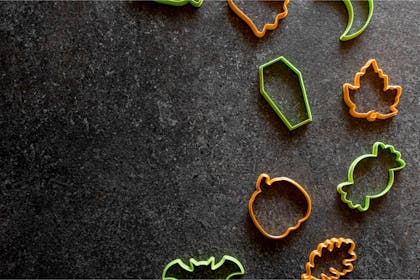 Halloween cookie cutters against grey background