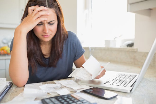 Woman looking at household bills