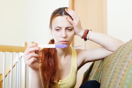 Woman looking at a pregnancy test