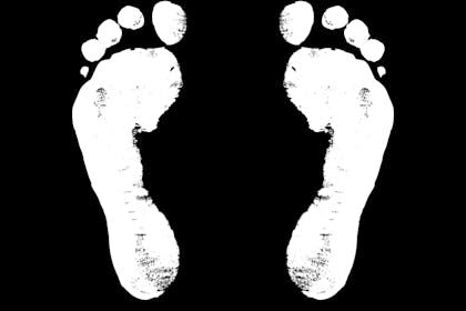 White footprint against black background