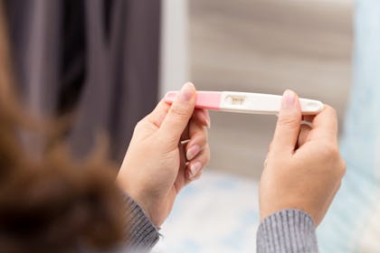 Woman holding a pregnancy test