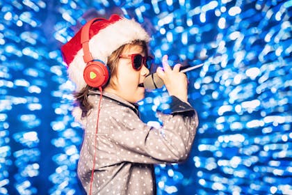 child in Christmas hat singing