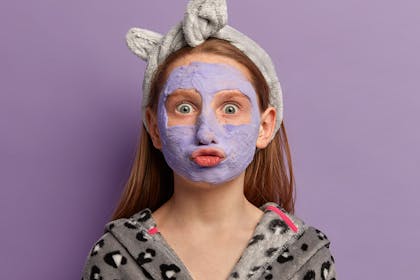 Teenager wearing purple face mask