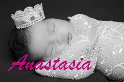 Sleeping baby wearing crown, text says Anastasia