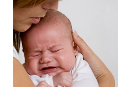 mother holding crying baby