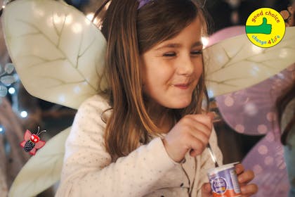 Girl dressed as fairy eating Petitis Filous