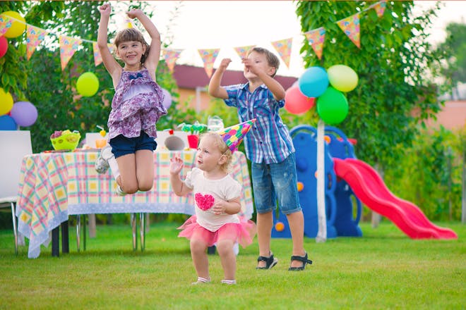 Three kids dancing at a birthday party
