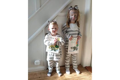 Two kids dressed as Mog the cat in grey stripped tops and trousers with cat ears