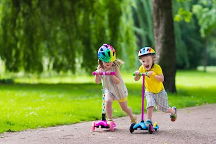 kids on scooters in park