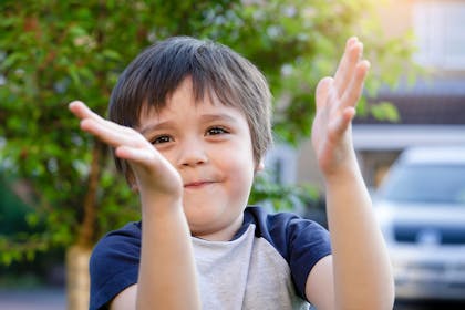 Young boy clapping hands
