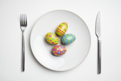 Easter eggs on plate with knife and fork
