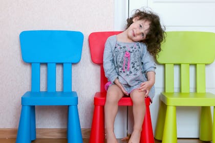 child sitting on chair