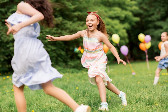 Young girls playing tag