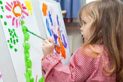 Girl paints in nursery