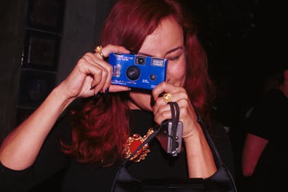 19. Taking photos on a disposable camera.