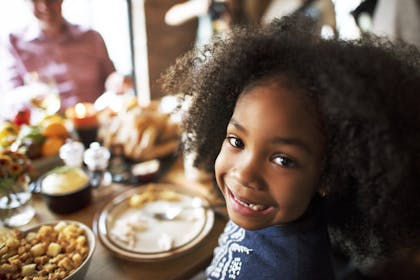 Close up of smiling child at dinner table