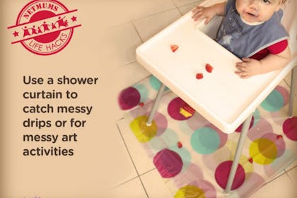 baby in high chair with polka dot shower curtain