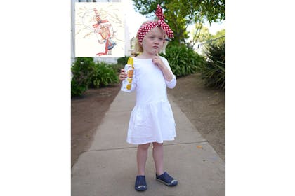 Girl dressed as Rosie Revere, Engineer with white dress and red and white spotted head scarf