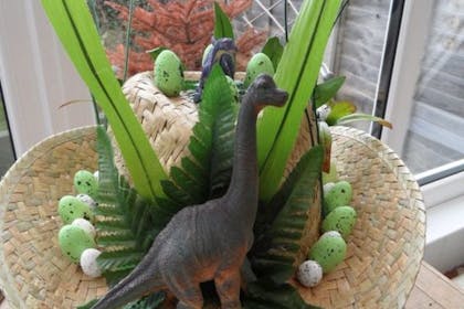 Easter bonnet with toy dinosaur stuck to the top