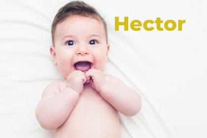 Baby lying on back smiling. Name Hector written in text