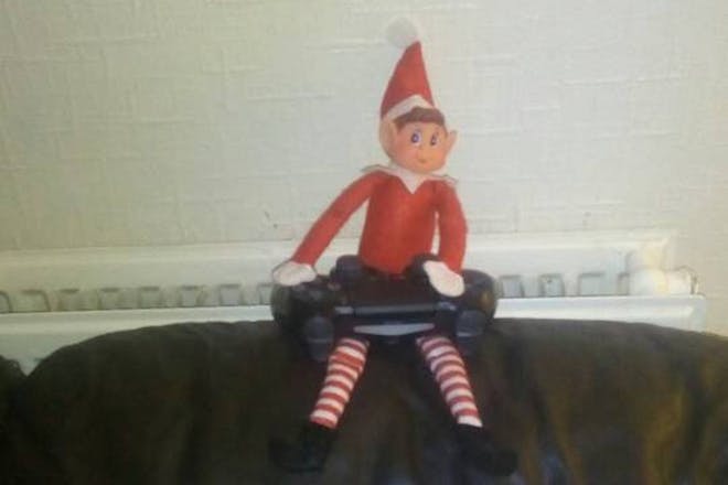 Elf on the shelf plays with Playstation controller