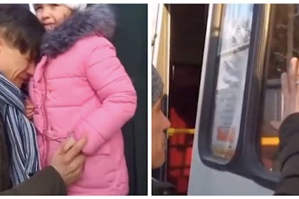 A Ukraine father saying goodbye to his young daughter as she boards a bus to safety 