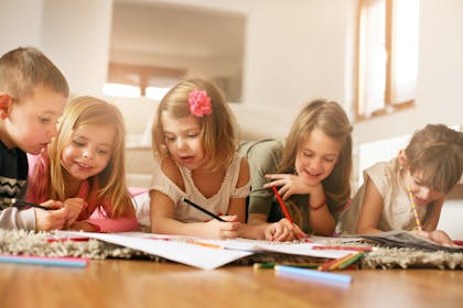 Group of children colouring in at home