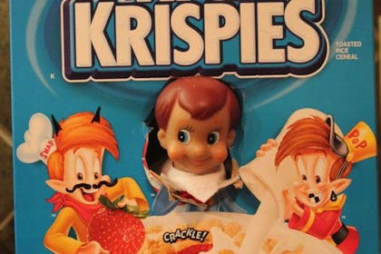 Christmas Elf on the Shelf hiding in Rice Krispies cereal box