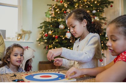 Kids playing a board game at christmas