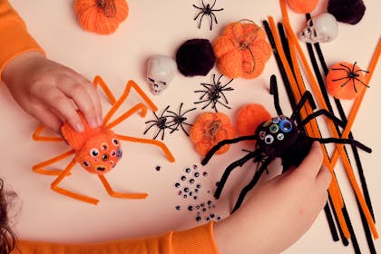 Orange and black pom pom spider craft for Halloween