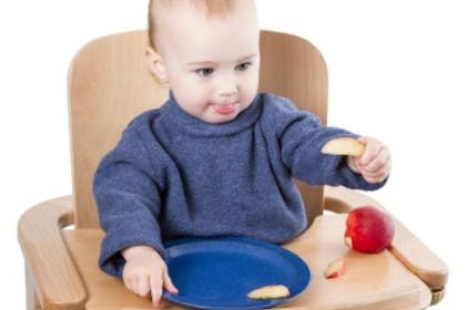 baby eating apple slices