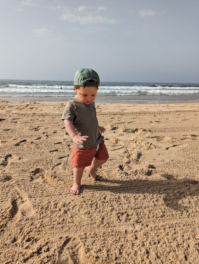 Toddler playing on beach