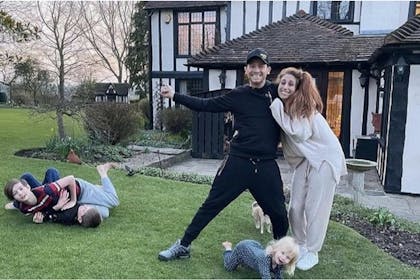 Stacey Solomon and Joe Swash and their children pose outside Pickle Cottage 