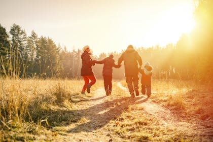 Family of four on a walk in the countryside in winter 