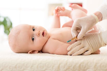 A baby receiving an injection from a doctor