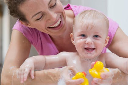 Mum bathing toddler