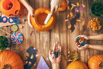 Table of Halloween treats, pumpkins and crafts