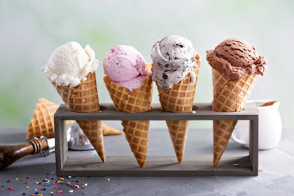 Four different ice cream cones in a rack