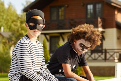 Two little boys dressed as a burglar and a skeleton