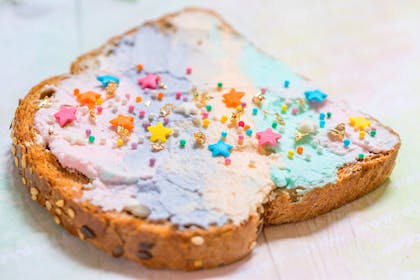 Toast with pastel coloured spread and sprinkles