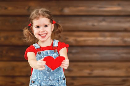 Little girl holding a heart