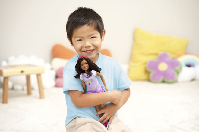 Boy playing with My First Barbie