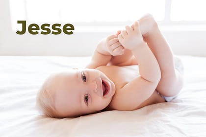Baby lying on back laughing and holding feet. Name Jesse written in text