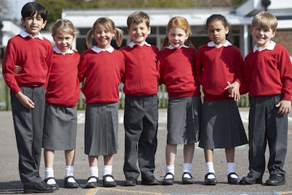 Group of primary school children standing together in uniform