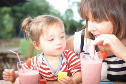 Mum and child drinking strawberry milkshakes