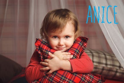 child holding red tartan pillow