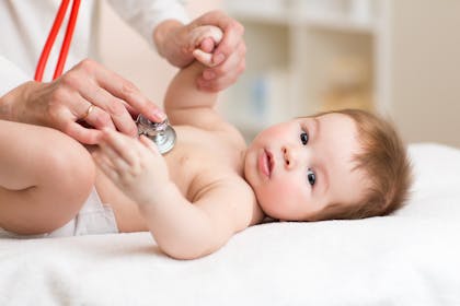 baby being checked by doctor