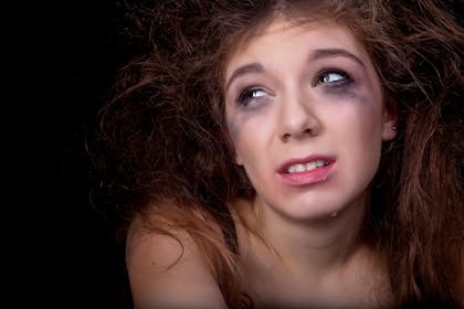 Teen crying with make up running down her face